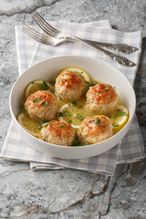 Chicken Piccata Meatballs Deliciously made with lemon zest, garlic, and a caper sauce closeup in the plate on the table. Vertical