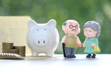 Mutual fund,Love couple senior and piggy bank with stack of coins money on natural green background, Save money for prepare in future and pension retirement concept