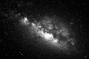 Stunning black and white image of a galaxy with swirling stars and cosmic dust in the background