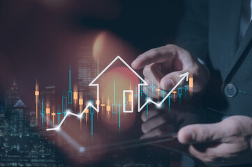 Businessman holding digital tablet in concept of real estate investment energy efficiency rating and property value, Real estate online. new home for the family, home search, land price, property tax