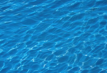 Gentle ripples on the surface of blue water, reflecting sunlight in a mesmerizing dance of light. A peaceful, calming image of fluid motion and natural elegance