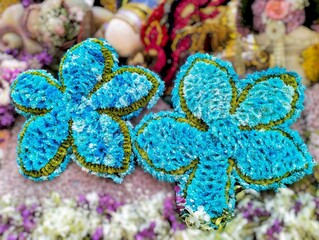 In the picture is a fresh flower decoration in a frame with green everlasting flowers used as the...