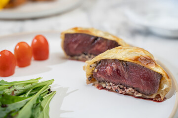 Gourmet beef wellington restaurant food photography elegant setting close-up culinary art