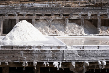 A pile of salt produced by the evaporation of water in an inland salt mine, with evaporation ponds on terraces built in wood at different levels, Añana salt mine