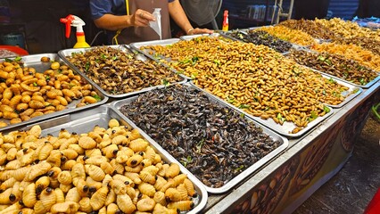 Exotic Edibles Showcase: A vibrant display of deep fried insect diverse, traditional delicacies, offering a culinary journey filled with textures and flavors.
