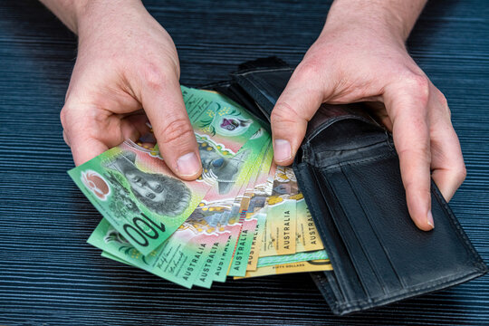 man count Australian dollar notes and take from a black wallet