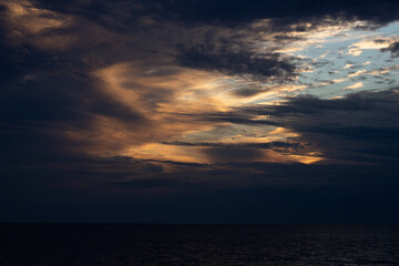 Beautiful dark colorful dramatic sky with clouds at sunset or sunrise.