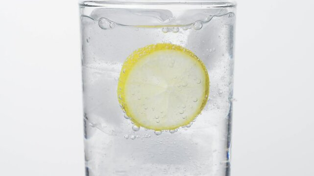 Soda bubble, Fizz in glass, ice and lemon, white background 4k 120fps