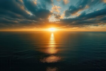 Fototapeta premium Sunset over calm ocean water with reflective sky and clouds, tranquil seascape, nature beauty, coastal landscape, serene evening, peaceful horizon.