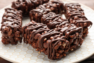 Delicious chocolate puffed rice bars on table, closeup