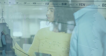 Image of currency and diagrams over diverse colleagues talking in office