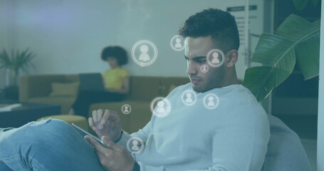 Image of media icons over caucasian casual businessman using smartphone in office