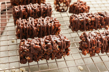 Delicious chocolate puffed rice bars on gray textured table, closeup
