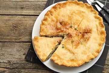 Delicious fresh homemade pie on wooden table, flat lay. Space for text
