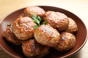 Delicious patties with parsley on table, closeup
