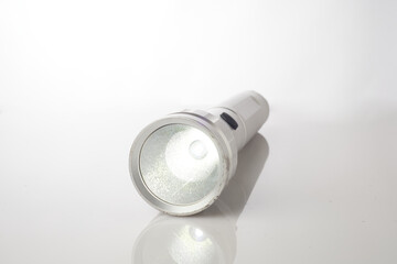 Bright Flashlight Placed on an Isolated Surface, Demonstrating Simplicity and Functionality
