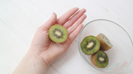 hand holding kiwi fruit palm