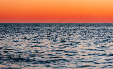 Horizon's Embrace: The vast ocean mirrors the fiery hues of the sunset, capturing the essence of tranquility and the beauty of nature's daily farewell.