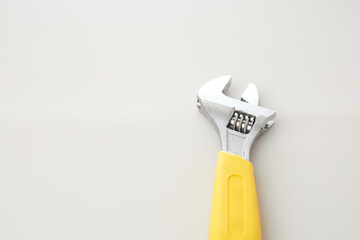 Adjustable Wrench With Yellow Handle Placed on Isolated Background
