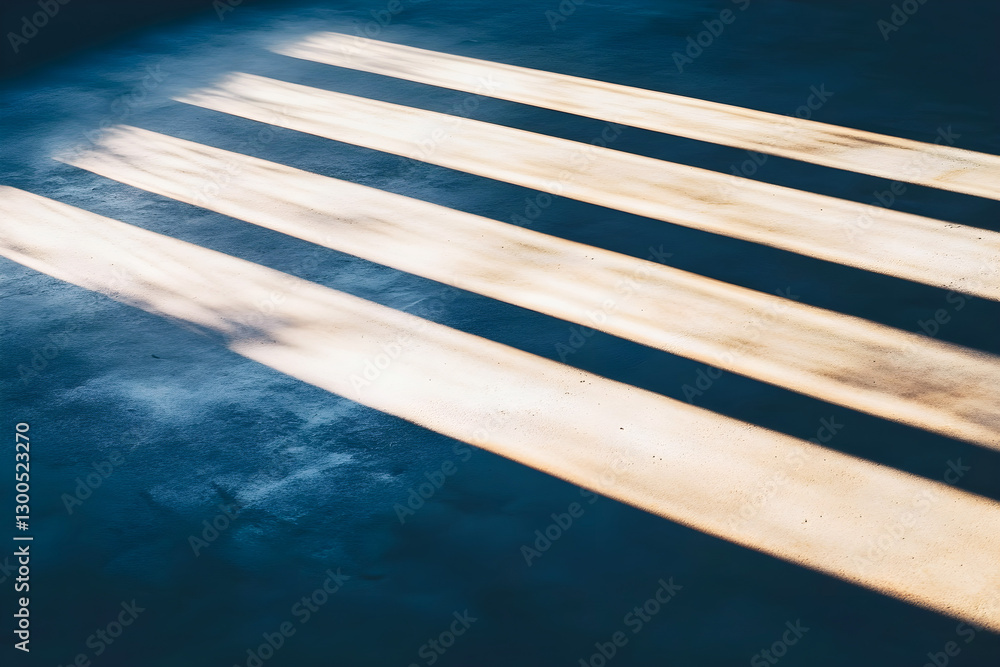 Poster long diagonal shadows cast by sunlight on a textured floor, creating a striking contrast between lig