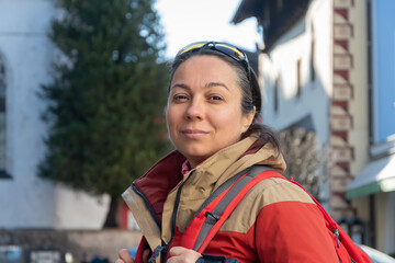 Smiling 40-45 year old woman with travel gear travelling in Europe.