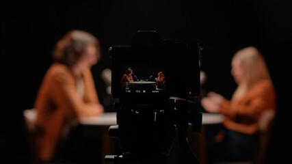 Engaging Dialogue Occurs in a Vibrant Studio Setting During a Podcast Recording Session