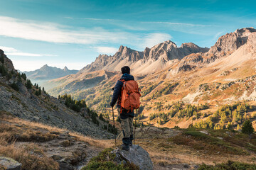 Obraz premium Male hiker hiking with enjoying the French Alps scenic on autumn wilderness in Claree Valley at France