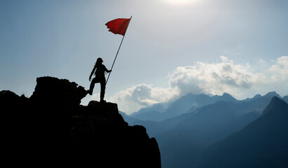 The mountain climber who reached the summit waved the victory flag and his success
