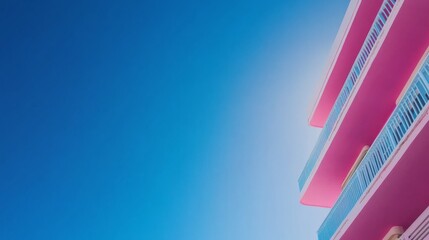 Obraz premium A colorful Art Deco building in Miami Beach displays bold geometric patterns and bright pastel hues, capturing the architectural beauty under a clear blue sky