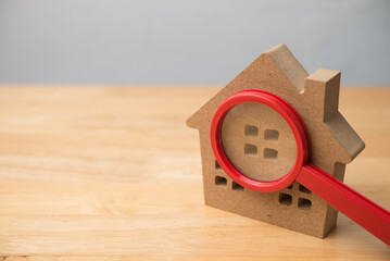 Magnifying glass lens zoom on house model copy space. Search for buying new or used home, price and...