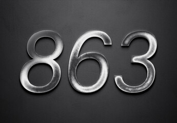 Chrome metal 3D number design of 863 on grey background.
