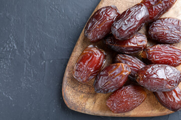 Tasty dried dates on grey table, top view. Space for text