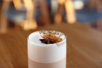 Glass of aromatic coffee on table in cafe, closeup