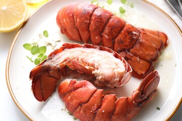 Delicious tails of boiled lobsters served on white table, closeup