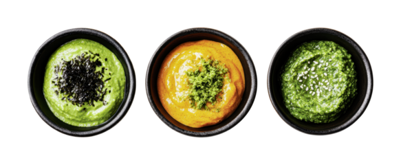 Colorful assortment of three distinct dips in small black bowls for entertaining and culinary enjoyment, cut out