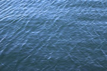 Ripples on blue water surface. Water background. Sea surface with small waves.