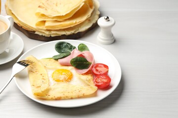 Delicious crepe with egg, ham and parmesan cheese served on white wooden table, space for text