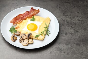 Delicious crepe bretonne with bacon, mushrooms and arugula on grey table, closeup