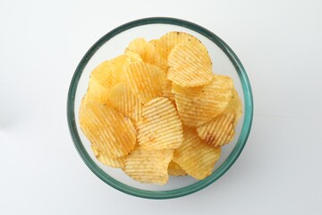 Tasty potato chips on white background, top view