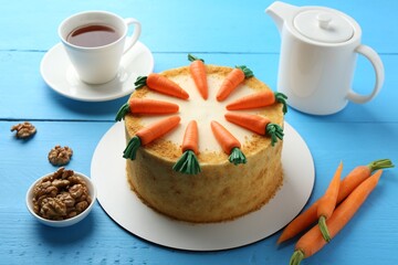 Delicious homemade carrot cake served on light blue wooden table