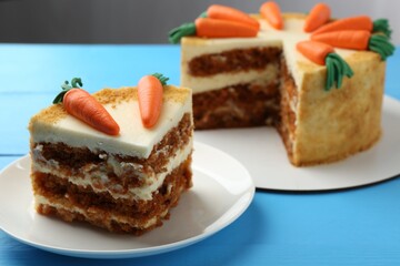 Delicious homemade carrot cake on light blue wooden table, closeup