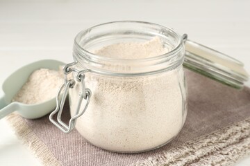 Brown rice flour on white table, closeup