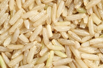 Pile of brown rice as background, top view