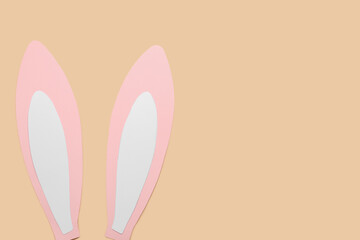 Paper bunny ears on beige background