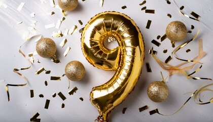 Gold balloon number 9 for ninth birthday or anniversary party. White background with confetti