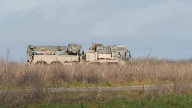 British army MAN HX SVR (Support Vehicle Recovery) 8x8 moving along a dirt track