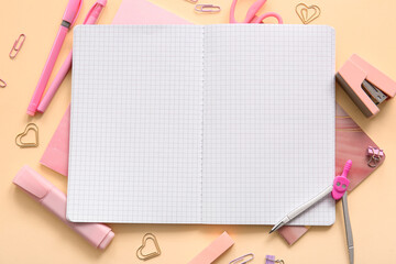 Composition with blank notebook and different school stationery on beige background, closeup