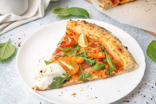 Slice of tasty pizza with Burrata cheese on grey background