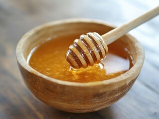 Golden honey brimming in a wooden bowl with dipper resting inside