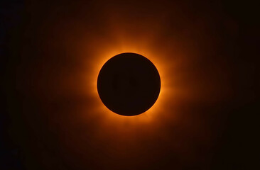 Obraz premium total solar eclipse, with the sun's corona forming a radiant halo around the darkened moon.
